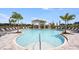Enjoy the community pool, furnished with lounge chairs, umbrellas and cabanas at 15172 Cuzcorro Ct, Nokomis, FL 34275