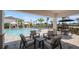 Outdoor lounge area overlooking the pool with comfortable seating and shaded spots at 15172 Cuzcorro Ct, Nokomis, FL 34275