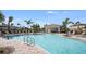 Sparkling community pool surrounded by ample lounge chairs and meticulously maintained landscaping at 15172 Cuzcorro Ct, Nokomis, FL 34275