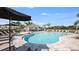 Stunning community pool with a covered lounge area and plenty of seating for residents at 15172 Cuzcorro Ct, Nokomis, FL 34275