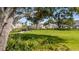 Community dog park with benches, black metal fence, and lush landscaping at 15192 Cuzcorro Ct, Nokomis, FL 34275