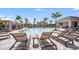 Resort-style pool area features ample lounge seating, cabanas and a covered outdoor kitchen at 15192 Cuzcorro Ct, Nokomis, FL 34275