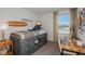 Charming bedroom featuring a themed surfboard, desk and storage platform bed at 15196 Cuzcorro Ct, Nokomis, FL 34275
