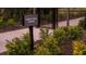 Legacy Trail Access sign leading to a community walking path surrounded by greenery at 15196 Cuzcorro Ct, Nokomis, FL 34275