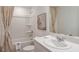 Bright bathroom with a shower-tub combo, vanity with a sink, mirror, and neutral decor at 15200 Cuzcorro Ct, Nokomis, FL 34275