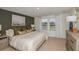 Stylish bedroom with a plush bed, neutral colors, and ample natural light at 15200 Cuzcorro Ct, Nokomis, FL 34275