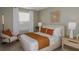 Comfortable bedroom with a plush bed, nightstands, decorative wall art, and soft natural light from the window at 15200 Cuzcorro Ct, Nokomis, FL 34275