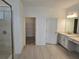 Elegant bathroom featuring double vanity, linen cabinets, glass shower, and walk-in closet at 1591 Laurel Brook Ln, Port Charlotte, FL 33953