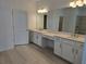 Beautiful primary bathroom featuring double vanity, walk-in closet and linen cabinets at 1591 Laurel Brook Ln, Port Charlotte, FL 33953