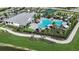 Aerial view of a beautiful community pool, tennis courts, and lush landscaping at 1591 Laurel Brook Ln, Port Charlotte, FL 33953