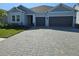 Charming single-story home featuring a paved driveway and a two-car garage at 1591 Laurel Brook Ln, Port Charlotte, FL 33953