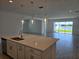 Modern kitchen island featuring elegant pendant lighting and an open floor plan at 1591 Laurel Brook Ln, Port Charlotte, FL 33953