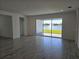 Bright living room with view of lake, featuring large sliding doors at 1591 Laurel Brook Ln, Port Charlotte, FL 33953