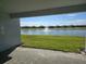 Stunning backyard view from the patio overlooking a serene lake and fountain at 1591 Laurel Brook Ln, Port Charlotte, FL 33953