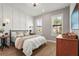 Inviting bedroom features natural light, stylish decor, and a comfortable bed, creating a relaxing atmosphere at 16226 Hidden Oak Loop, Lakewood Ranch, FL 34211
