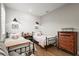 Well-lit ' bedroom with twin beds, showcasing a minimalist design and a cozy, inviting atmosphere at 16226 Hidden Oak Loop, Lakewood Ranch, FL 34211