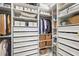 Organized walk-in closet featuring custom shelving, drawers, and baskets, maximizing storage and convenience at 16226 Hidden Oak Loop, Lakewood Ranch, FL 34211