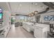A modern clubhouse with a kitchen island, sink, lots of windows, and plenty of seating for residents and guests at 16226 Hidden Oak Loop, Lakewood Ranch, FL 34211