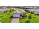 Aerial front view of this lovely home with a manicured lawn and landscaping at 16226 Hidden Oak Loop, Lakewood Ranch, FL 34211