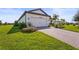 Charming single-Gathering home featuring a well-manicured lawn, paver driveway, and an attached two-car garage at 16226 Hidden Oak Loop, Lakewood Ranch, FL 34211