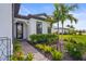 Inviting front entrance showcasing a manicured garden, walkway and a glass paneled door for the home at 16226 Hidden Oak Loop, Lakewood Ranch, FL 34211