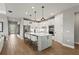 Open-concept kitchen featuring a large island, stainless steel appliances, and wood-style floors at 16226 Hidden Oak Loop, Lakewood Ranch, FL 34211