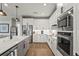 Modern kitchen with stainless steel appliances, sleek white cabinetry, and a stylish faucet at 16226 Hidden Oak Loop, Lakewood Ranch, FL 34211