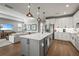 Bright kitchen featuring a spacious island, stainless steel appliances, and seamlessly connected living area at 16226 Hidden Oak Loop, Lakewood Ranch, FL 34211