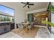 Outdoor dining area featuring a grill, table with seating, and view into the living room at 16226 Hidden Oak Loop, Bradenton, FL 34211