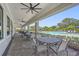 An outdoor patio seating area overlooking the beautiful community pool and lounge seating at 16226 Hidden Oak Loop, Lakewood Ranch, FL 34211