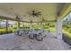 An open-air pavilion with picnic tables and ceiling fans, providing a comfortable space for outdoor dining and gatherings at 16226 Hidden Oak Loop, Lakewood Ranch, FL 34211