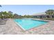 A sparkling, resort-style pool with blue umbrellas and lots of lounge seating at 16226 Hidden Oak Loop, Lakewood Ranch, FL 34211