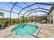 Screened-in pool with water features, sun loungers, and mature landscaping creating a private backyard oasis at 16226 Hidden Oak Loop, Lakewood Ranch, FL 34211