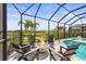 Inviting screened-in pool area with a fire pit and comfortable seating, perfect for outdoor entertaining at 16226 Hidden Oak Loop, Lakewood Ranch, FL 34211