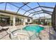 The screened-in pool area has a spa, fountain and a seating area outside at 16226 Hidden Oak Loop, Bradenton, FL 34211