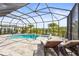 This screened-in pool area has lounge chairs and access to the lake at 16226 Hidden Oak Loop, Lakewood Ranch, FL 34211