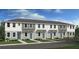 Charming townhome featuring a modern exterior, well-manicured lawn, and inviting entryway at 16534 San Nicola Pl, Lakewood Ranch, FL 34211