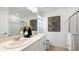 Bright bathroom featuring double sinks, quartz countertops, decorative art, and glass enclosed shower at 16554 San Nicola Pl, Lakewood Ranch, FL 34211