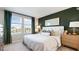 Comfortable bedroom featuring a large window, neutral decor, and ample natural light at 16554 San Nicola Pl, Lakewood Ranch, FL 34211