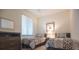 Comfortable bedroom with two beds, dresser, and a window with blinds offering privacy at 17108 Vardon Ter # 401, Bradenton, FL 34211