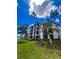 Exterior of the building showing lake view, balconies and lush landscaping at 17108 Vardon Ter # 401, Bradenton, FL 34211