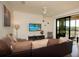 Inviting living room with comfortable seating, ceiling fan, and sliding glass doors to a patio at 17108 Vardon Ter # 401, Bradenton, FL 34211