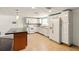 Modern kitchen featuring white appliances, ample cabinetry, and tile backsplash at 1741 Font Ln, Holiday, FL 34691