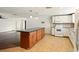 Open kitchen with a center island, white cabinets, and modern appliances at 1741 Font Ln, Holiday, FL 34691