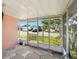 Screened porch with stone flooring and view of the neighborhood at 1741 Font Ln, Holiday, FL 34691