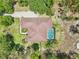 Aerial view showcases a pool and patio set within a private, tree-lined backyard at 18026 Nutcracker Rd, Weeki Wachee, FL 34614