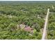 Aerial shot of a home with a swimming pool nestled among lush greenery and trees, creating a private oasis at 18026 Nutcracker Rd, Weeki Wachee, FL 34614