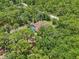 Aerial view of a secluded home with a pool surrounded by lush trees and greenery at 18026 Nutcracker Rd, Weeki Wachee, FL 34614