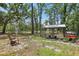 Backyard area featuring a chicken coop and run, surrounded by mature trees and open space, ideal for hobby farming at 18026 Nutcracker Rd, Weeki Wachee, FL 34614