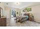 Bright bedroom features sliding glass doors to the pool and an ensuite bathroom at 18026 Nutcracker Rd, Weeki Wachee, FL 34614